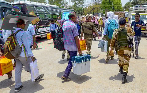 Polling officials along with EVMs ahead of phase 7 polling.